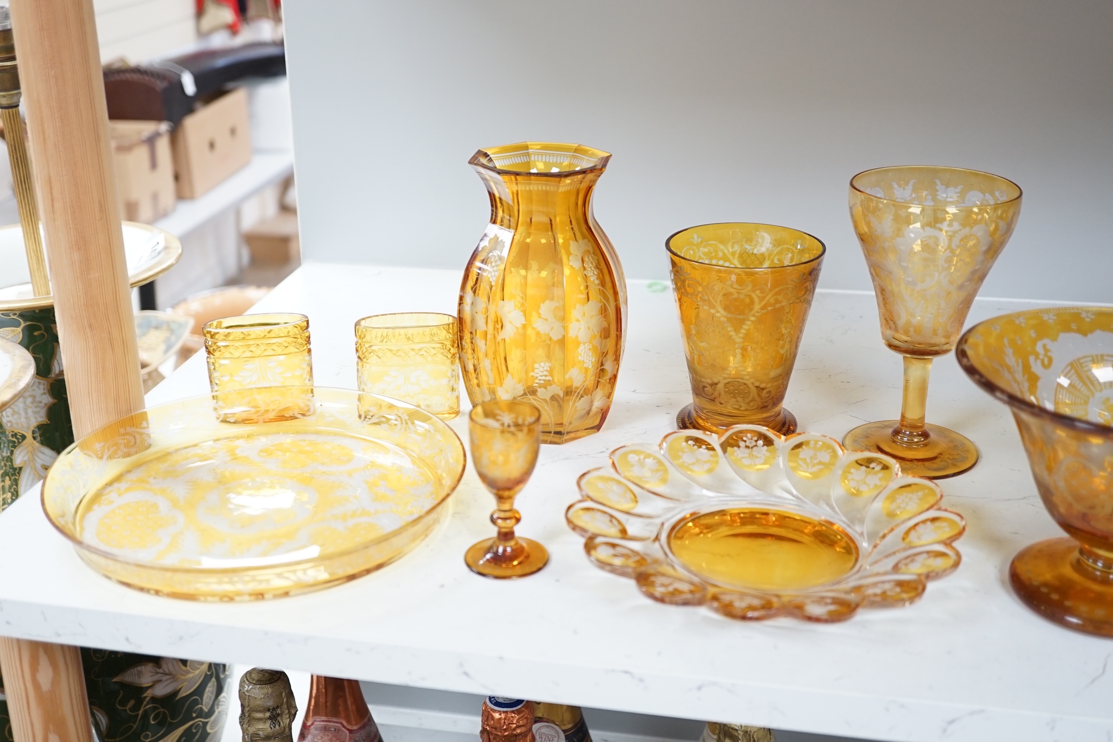 A collection of mostly Bohemian amber flashed cut glassware to include dishes, glasses and a silver topped atomiser, largest 22cm in diameter. Condition - mostly fair